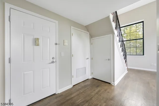 an empty room with windows and closet