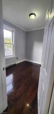 a view of a room with window and wooden floor