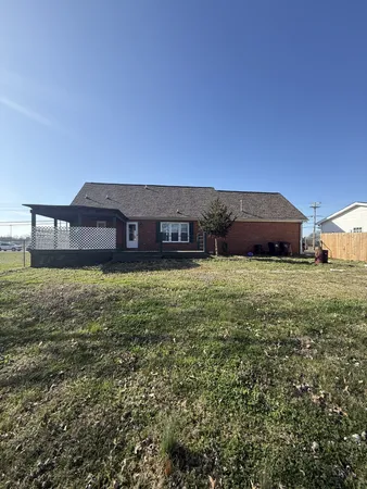 a view of a house with yard and sitting area