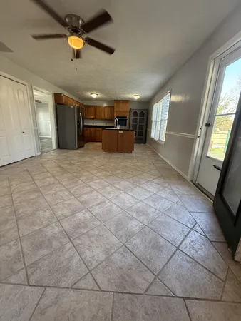a view of empty room with a window and fireplace