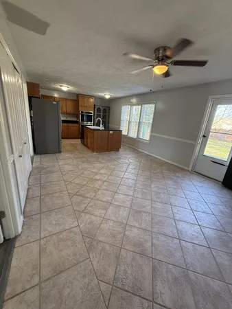 a view of a livingroom with furniture and a window