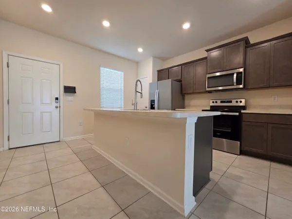 a kitchen with stainless steel appliances granite countertop a refrigerator and a stove