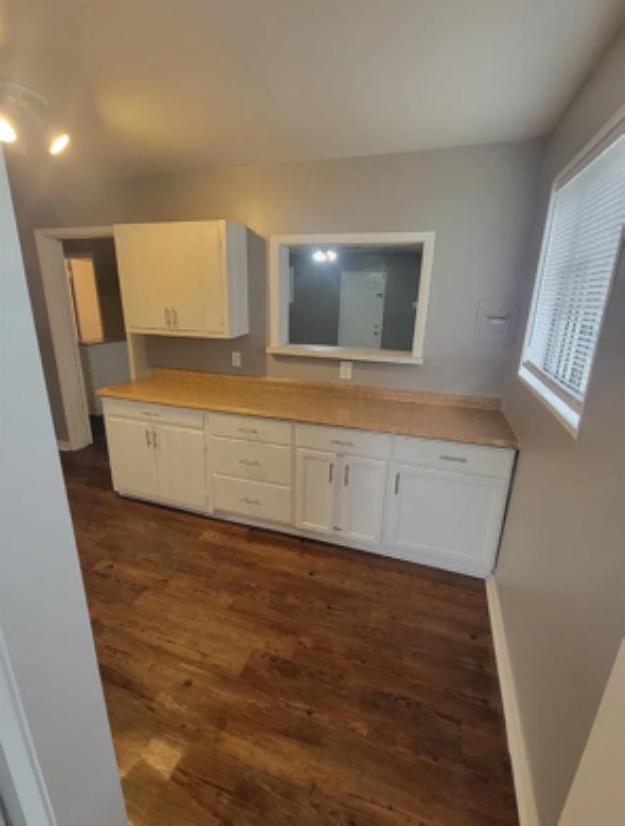 386 Elder Road Memphis, TN 38109 - Photo 5 of 12 a view of an empty room with wooden floor and a window