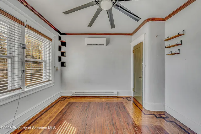 a view of room with window and wooden floor