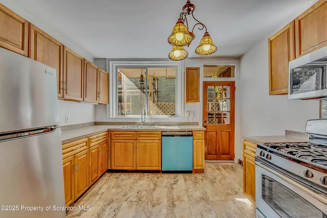 a kitchen with stainless steel appliances granite countertop a stove and a sink
