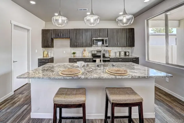 a kitchen with sink a counter top space and appliances