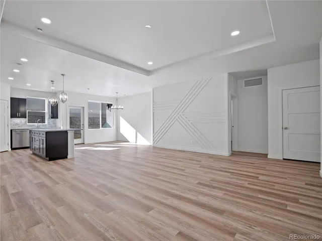 a large kitchen with stainless steel appliances granite countertop a sink refrigerator and microwave