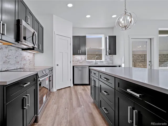 a large bedroom with a large bed and a chandelier