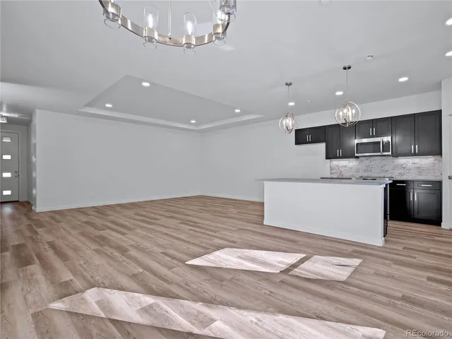a bathroom with a granite countertop sink a large mirror and shower
