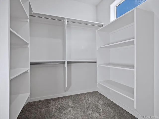 a bathroom with a sink a toilet a mirror and shower