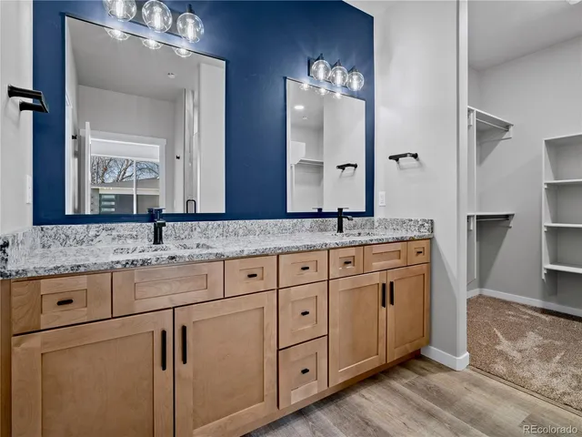 a bathroom with double sink and a mirror