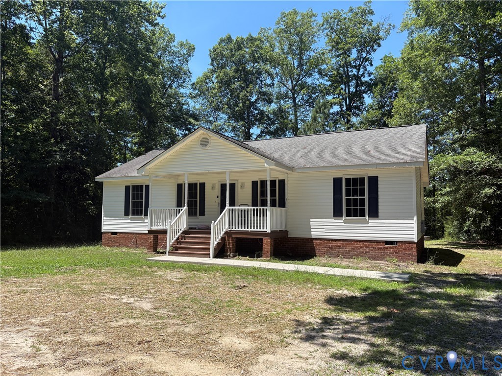 14002 Sunnybrook Road Petersburg, VA 23805 - Photo 17 of 21 White siding exterior with a partial brick foundat