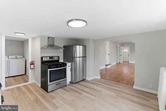 a kitchen with stainless steel appliances granite countertop a sink and a refrigerator