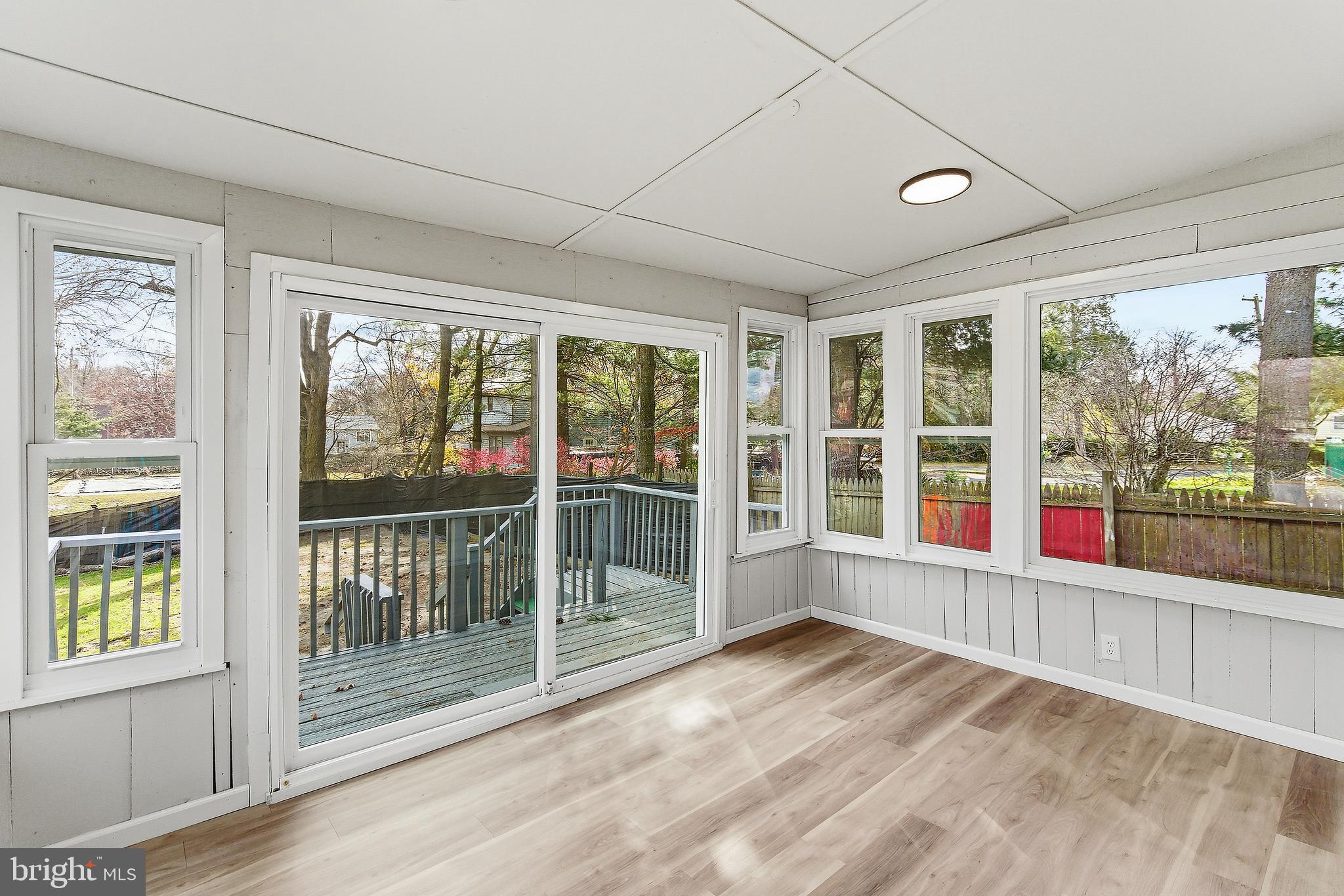 409 Cedar Avenue Lindenwold, NJ 08021 - Photo 17 of 25 an empty room with wooden floor and windows