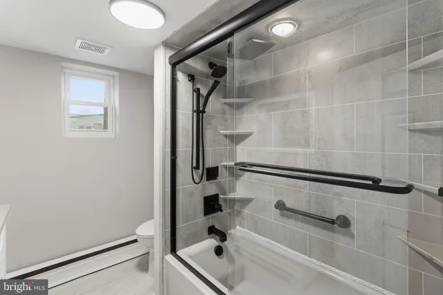 a bathroom with a tub and a shower