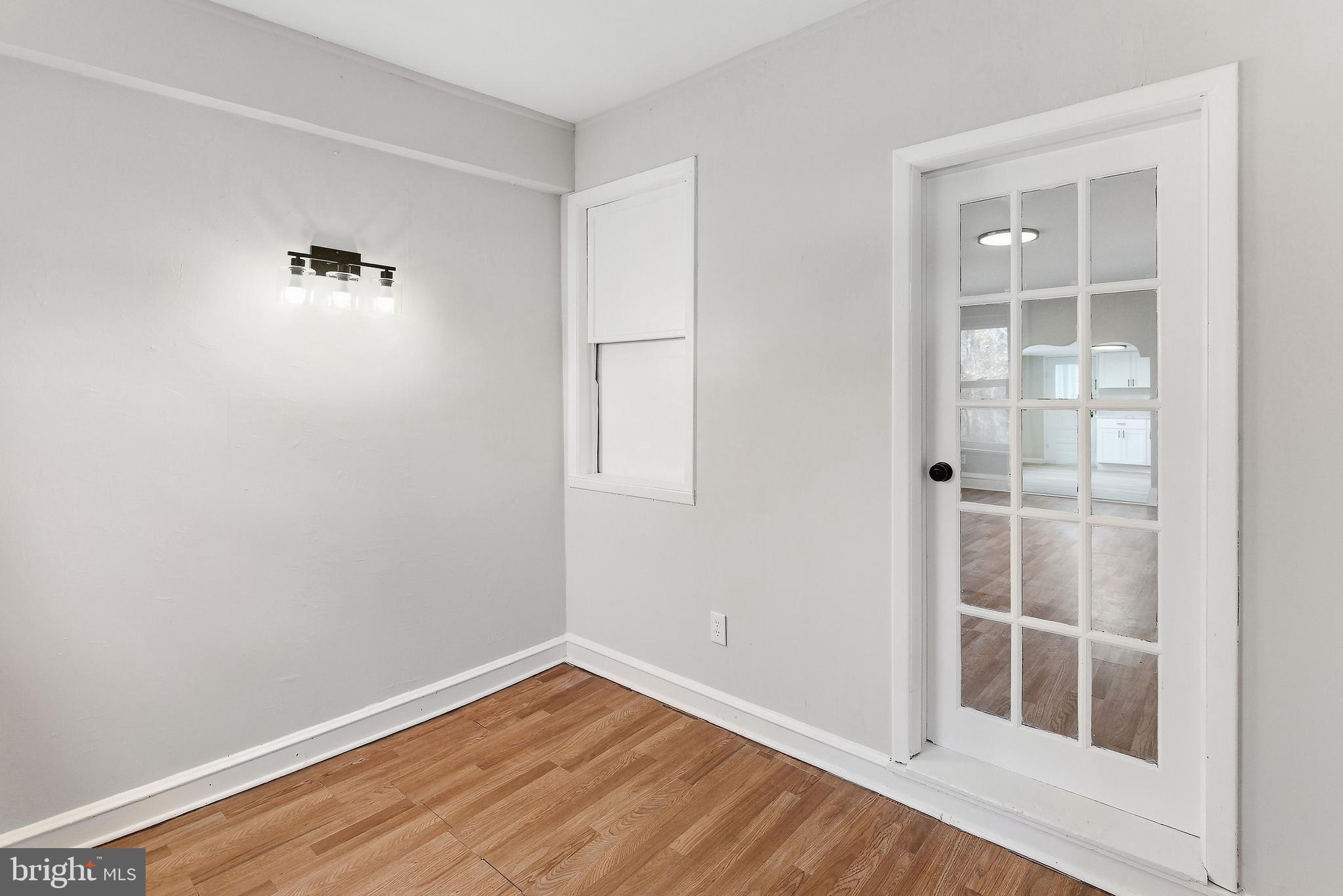 409 Cedar Avenue Lindenwold, NJ 08021 - Photo 5 of 25 an empty room with wooden floor and windows