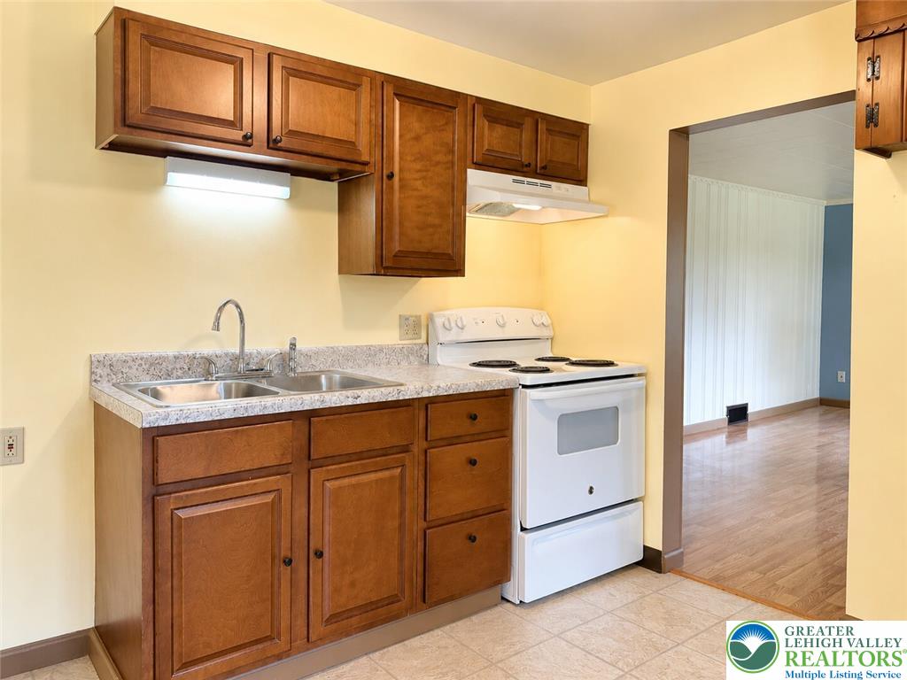 4995 Mountain Road Slatington, PA 18080 - Photo 10 of 30 Well-maintained kitchen featuring warm wood cabinetry and durable countertops, ready for daily living.