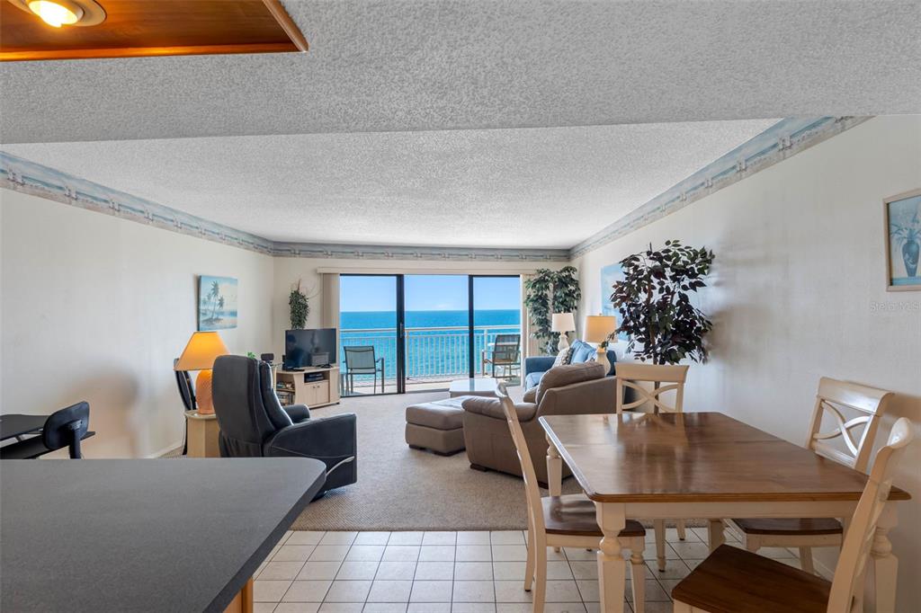19440 Gulf Boulevard, Unit 506 Indian Rocks Beach, FL 33785 - Photo 11 of 67 a living room with furniture potted plant and a large window