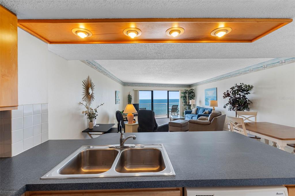 19440 Gulf Boulevard, Unit 506 Indian Rocks Beach, FL 33785 - Photo 13 of 67 a room with a sink and view of living room