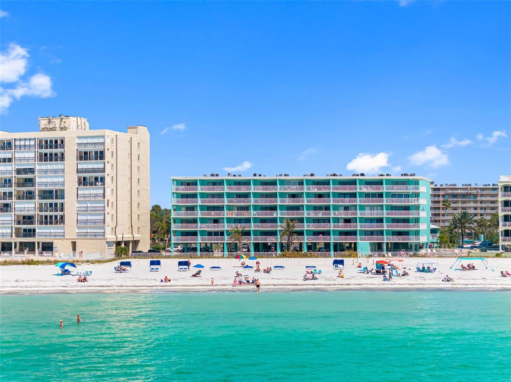 19440 Gulf Boulevard, Unit 506 Indian Rocks Beach, FL 33785 - Photo 29 of 67 a front view of building with play ground and yard