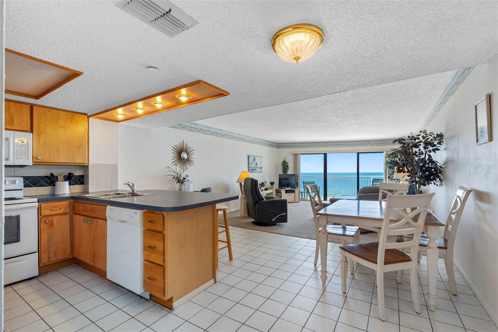 19440 Gulf Boulevard, Unit 506 Indian Rocks Beach, FL 33785 - Photo 3 of 67 a view of a dining room kitchen with furniture and chandelier