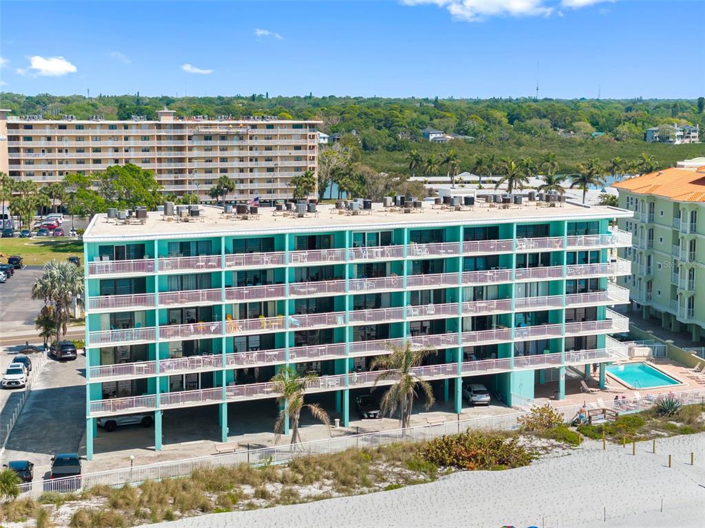 19440 Gulf Boulevard, Unit 506 Indian Rocks Beach, FL 33785 - Photo 44 of 67 a view of a large building with a yard