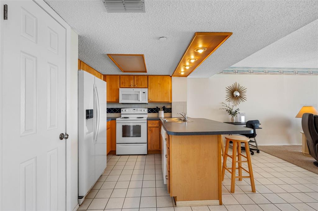 19440 Gulf Boulevard, Unit 506 Indian Rocks Beach, FL 33785 - Photo 54 of 67 a kitchen with a sink appliances and cabinets