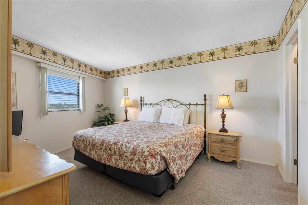 19440 Gulf Boulevard, Unit 506 Indian Rocks Beach, FL 33785 - Photo 56 of 67 a bedroom with a bed and a night stand next to a window