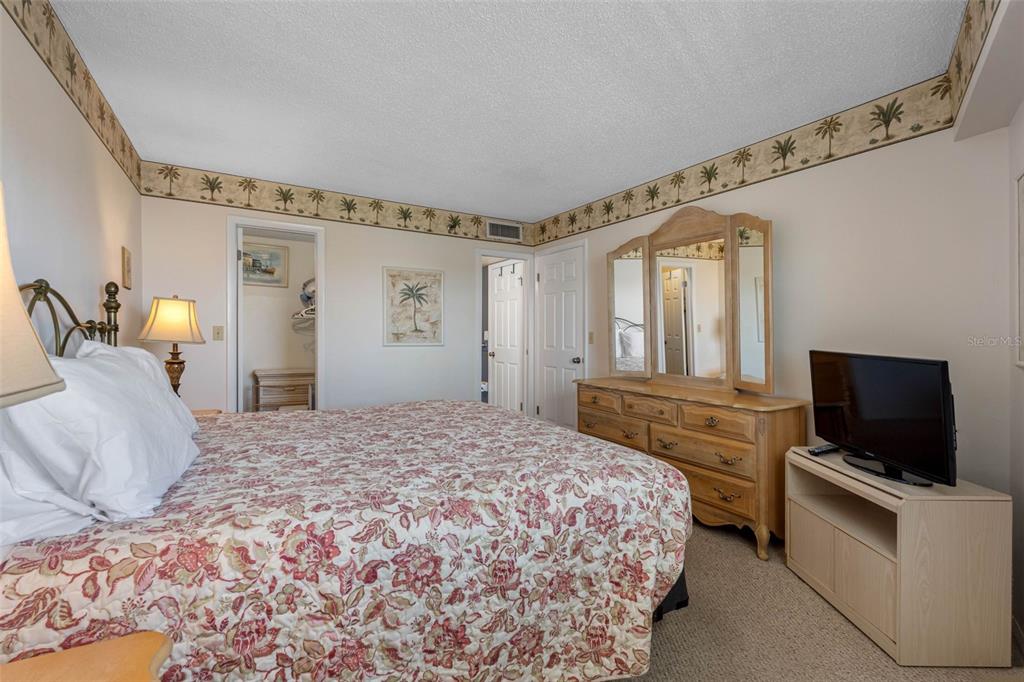 19440 Gulf Boulevard, Unit 506 Indian Rocks Beach, FL 33785 - Photo 60 of 67 a bedroom with a bed and a flat screen tv