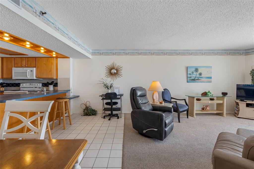 19440 Gulf Boulevard, Unit 506 Indian Rocks Beach, FL 33785 - Photo 64 of 67 a living room with furniture and a flat screen tv