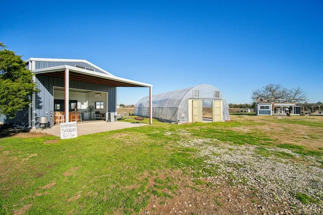 a view of a house with backyard and porch