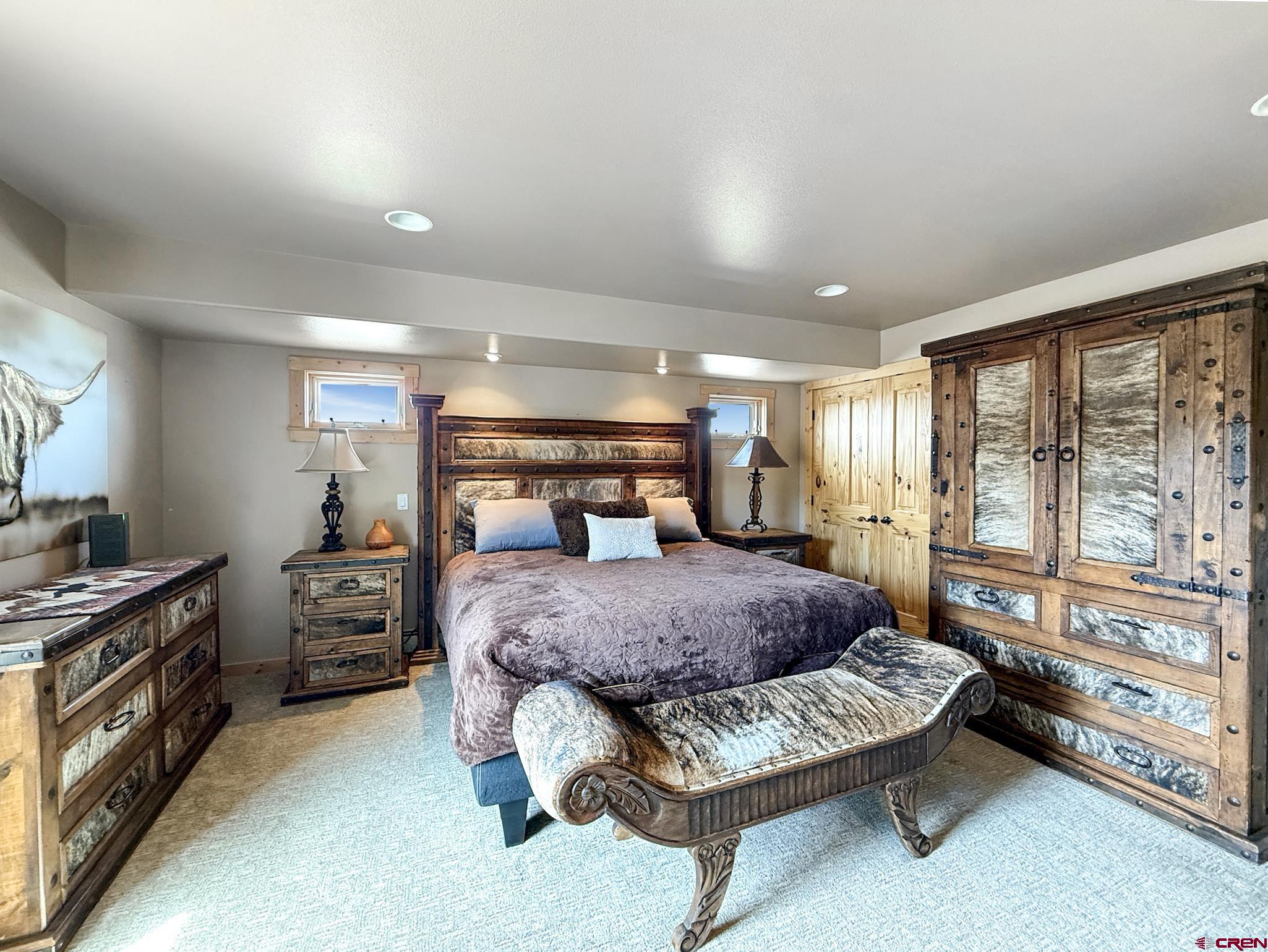 1190 7745 Road Crawford, CO 81415 - Photo 19 of 43 a bedroom with a bed and large windows