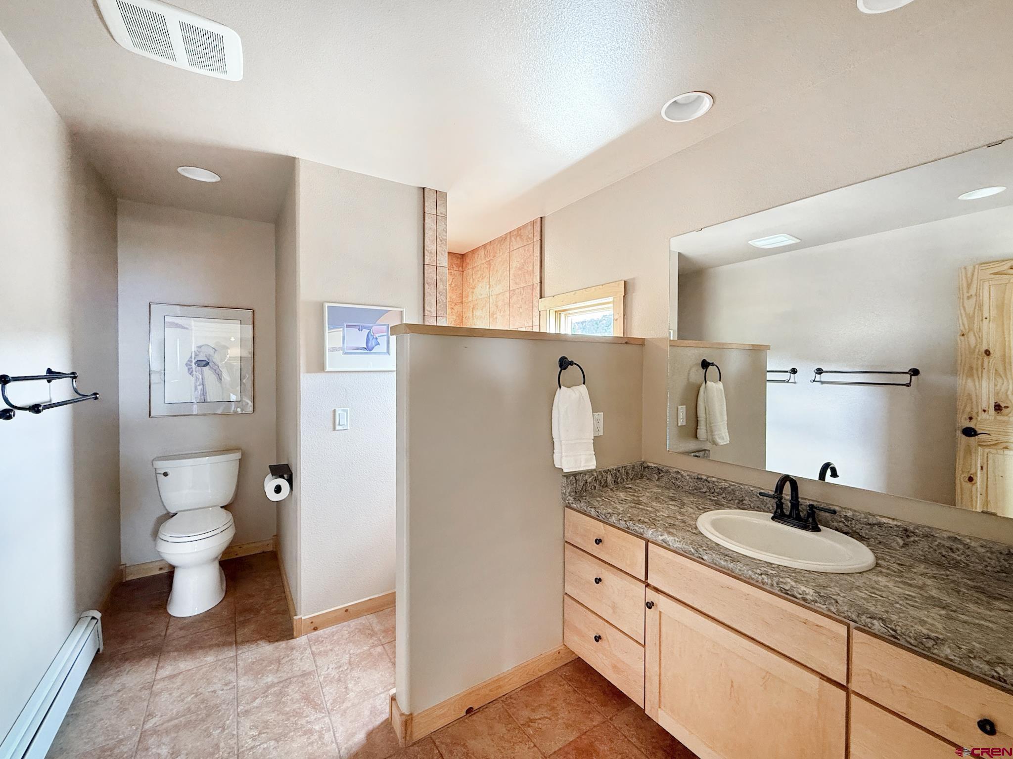 1190 7745 Road Crawford, CO 81415 - Photo 20 of 43 a bathroom with a granite countertop sink toilet and shower