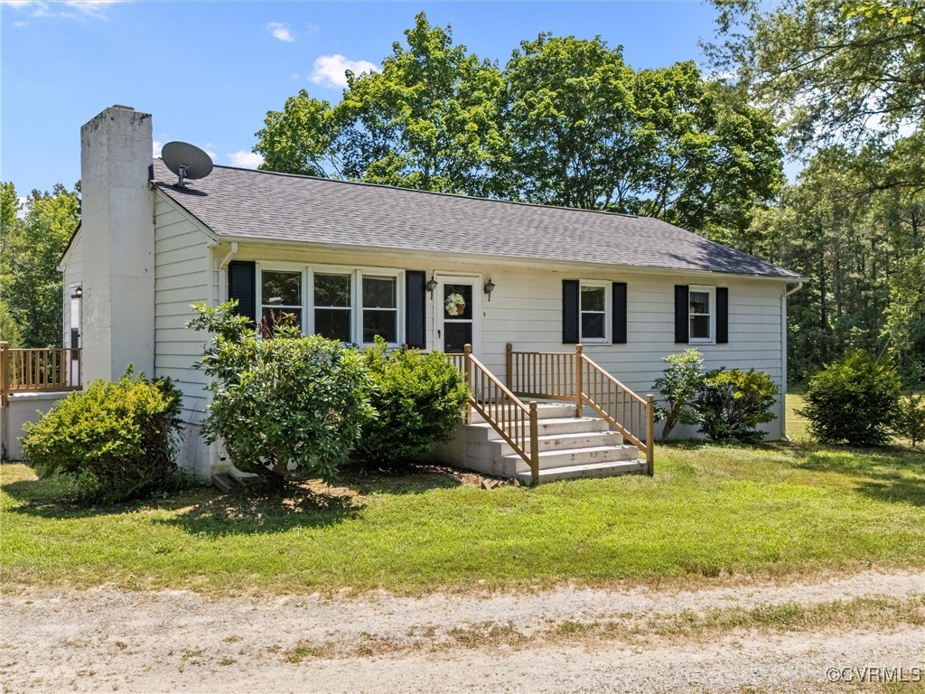 7224 Cedar Fork Road Ruther Glen, VA 22546 - Photo 1 of 1 a front view of a house with a garden