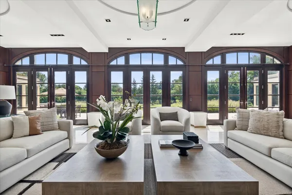 a bedroom with a bed and large windows