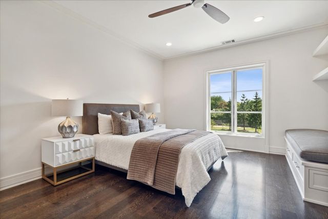 a view of swimming pool with lawn chairs under an umbrella