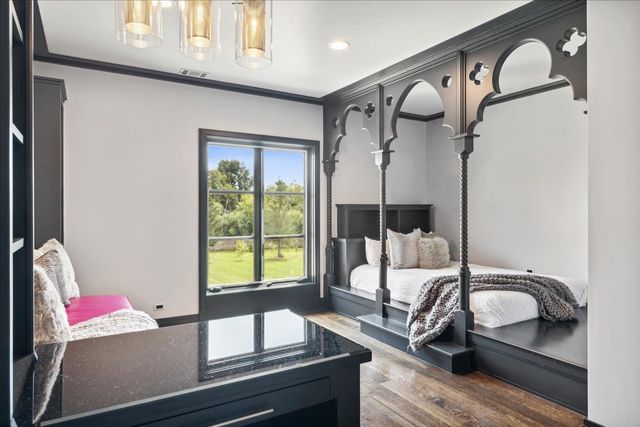 an aerial view of a city with lots of residential buildings and green landscape