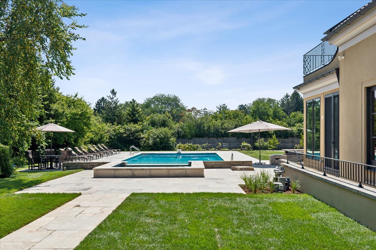 261 East Onwentsia Road Lake Forest, IL 60045 - Photo 61 of 65 a view of swimming pool with lawn chairs under an umbrella