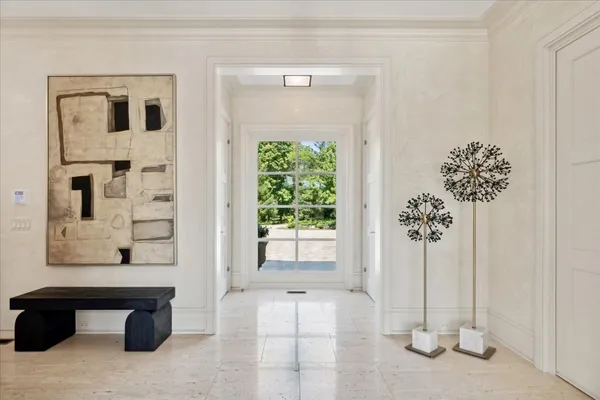 a living room with furniture a large window and a fireplace