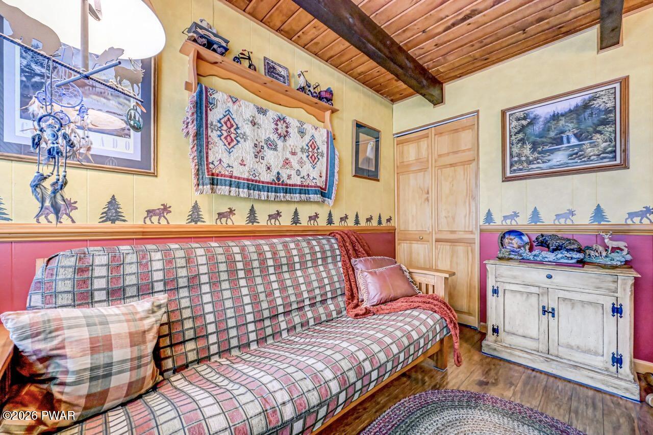 103 Forest Drive Hawley, PA 18428 - Photo 48 of 85 a bedroom with a bed and wooden floor