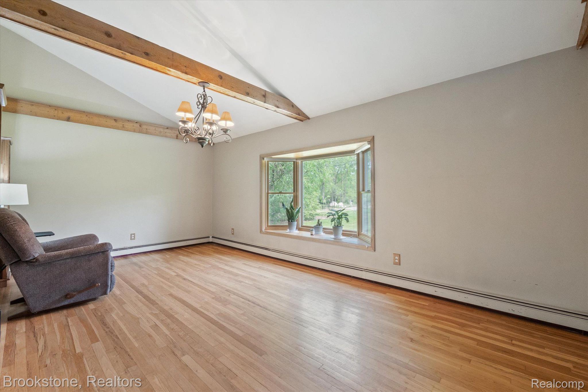 2869 Judah Road Lake Orion, MI 48359 - Photo 9 of 52 DINING ROOM W/ VAULTED CEILINGS AND WOOD BEAMS