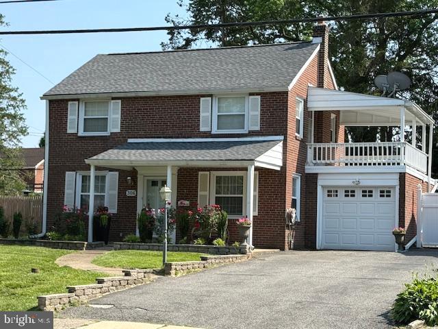 306 East Springfield Road Springfield, PA 19064 - Photo 2 of 40 a front view of a house with a garden