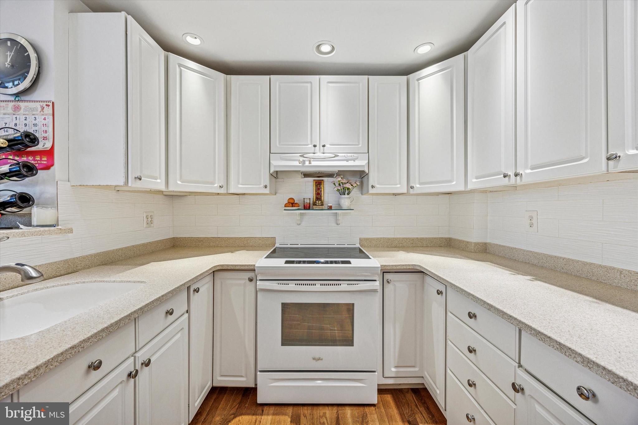 306 East Springfield Road Springfield, PA 19064 - Photo 21 of 40 a view of a kitchen with cabinets appliances and wooden floor