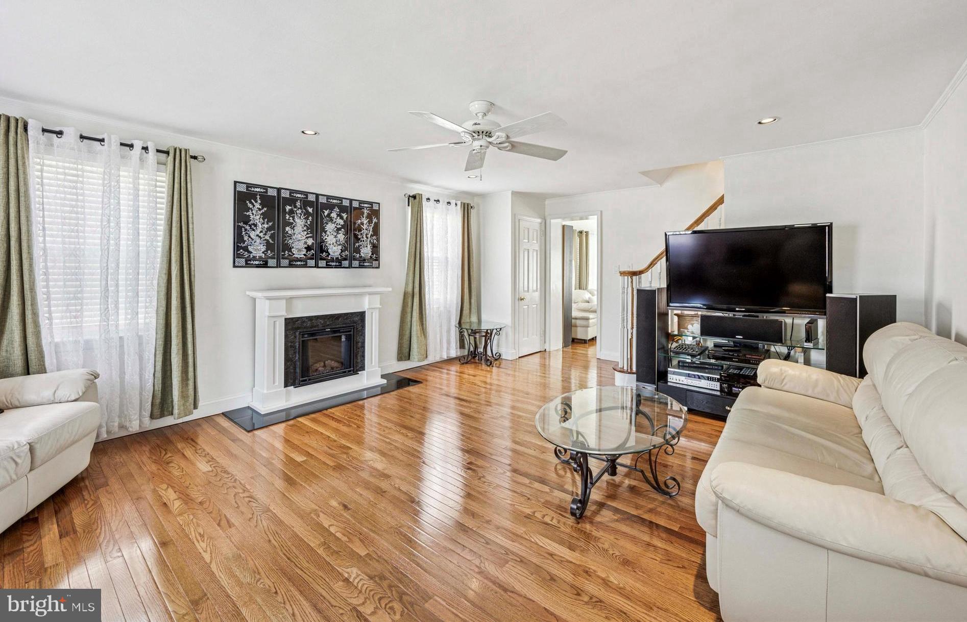 306 East Springfield Road Springfield, PA 19064 - Photo 10 of 40 a living room with furniture a fireplace and a flat screen tv