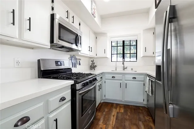 a kitchen with cabinets appliances and a window