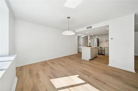 a view of a kitchen with a sink hardwood floor and a fireplace