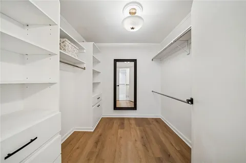 a view of a hallway view with wooden floor and staircase