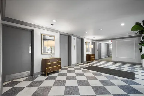 a view of living room and kitchen with furniture and a rug