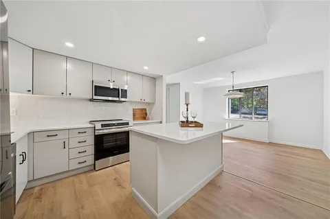 a kitchen with a sink appliances and cabinets