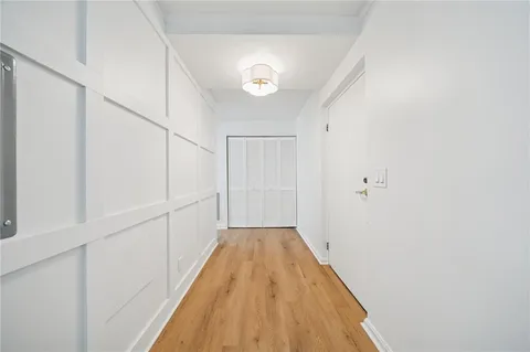 a view of a hallway with wooden floor